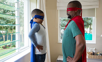 father and son dressed up in superhero costumes
