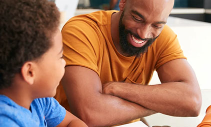 Black man and boy laughing together