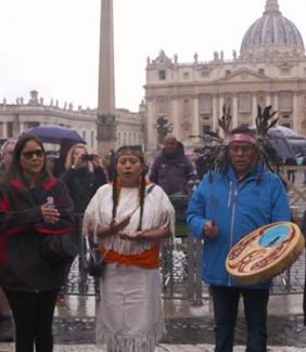 Indigenous delegates hold a ceremony in St. Peter's Square outside the Vatican