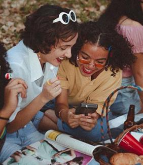 teens smiling at a cell phone