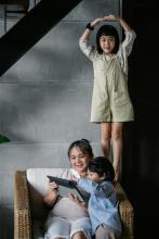 Photo of parent and two children playing