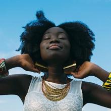 Black woman smiling with her eyes closed