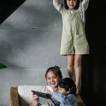 Photo of parent and two children playing