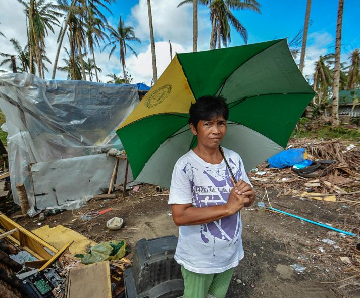 Woman holding green, yellow, and white umbrella