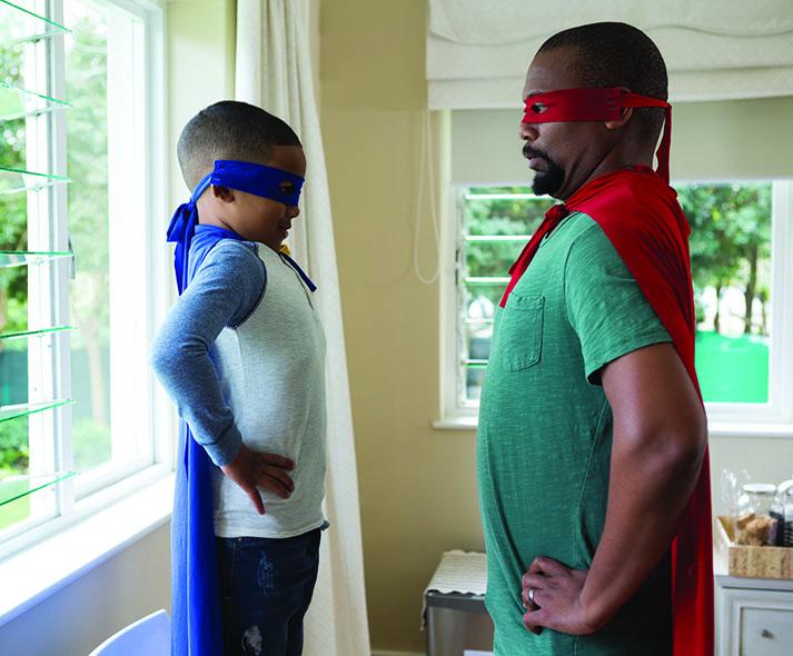 father and son dressed up as superheros
