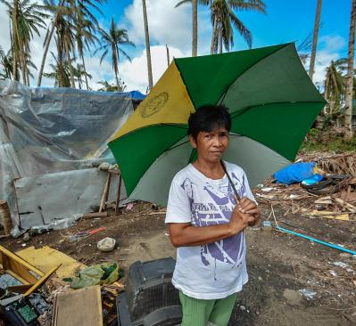Woman holding green, yellow, and white umbrella