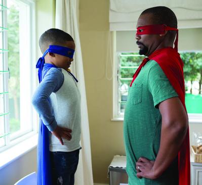 father and son dressed up as superheros